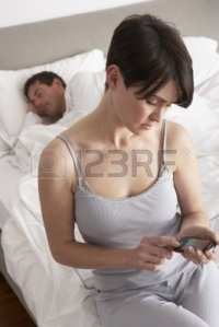 9911276-suspicious-wife-checking-husband-s-mobile-phone-whilst-he-sleeps
